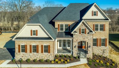 grey colored shingle roof on a tan stone house